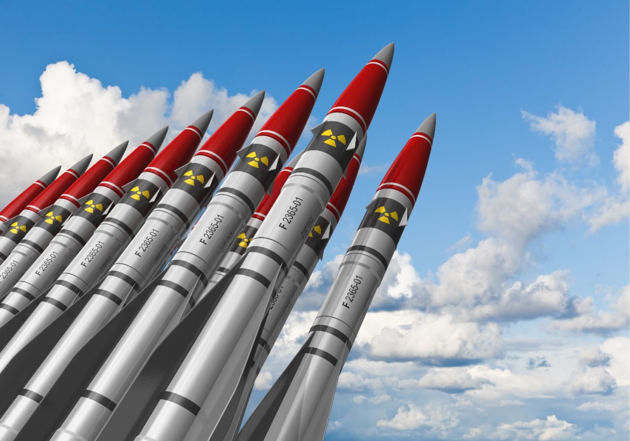 Row-of-heavy-nuclear-missiles-against-blue-sky-with-clouds-1280×896